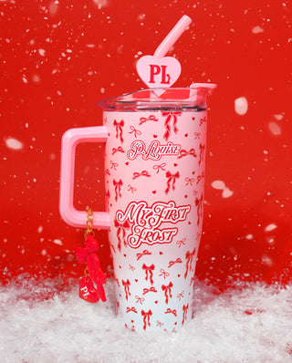 Pink P.Louise Christmas Frost Cup in kids size with 'P. Louise' branding and red ribbon design on a red background surrounded by snow