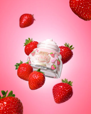 Jar of P. Louise soft sundae ice cream whipped moisturiser surrounded by strawberries on a pink background