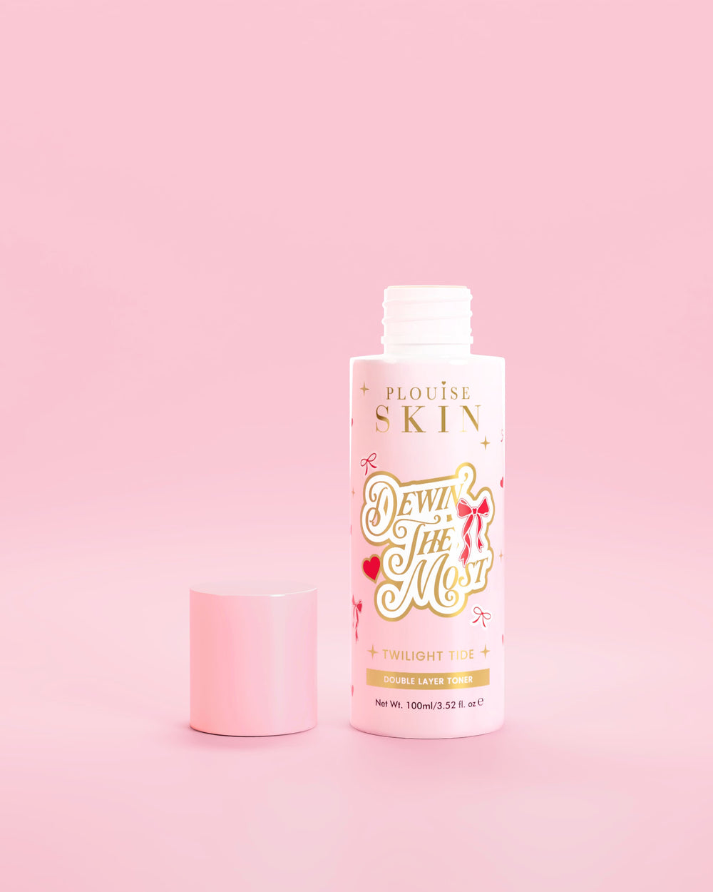 Pink bottle of P.Louise Dewin The MOst Double Layer Toner with red bow designs against a pink background 